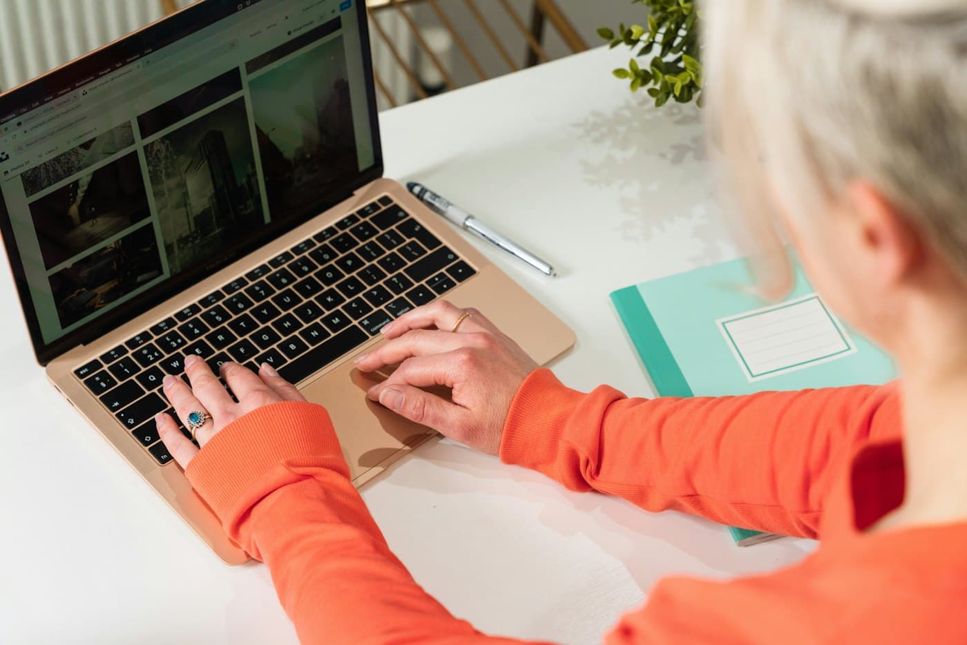 Person designing a website on a laptop